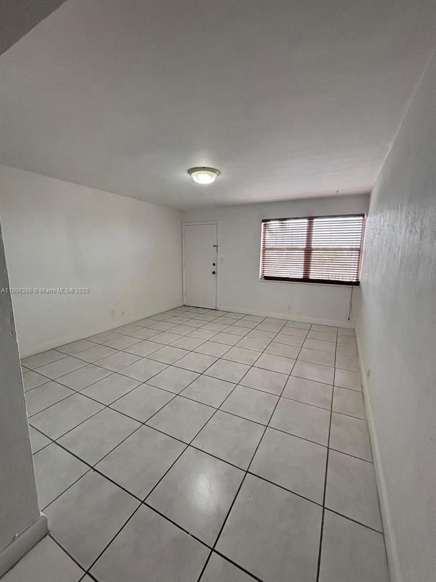 11005 Southwest 1st Street, Unit 302 Sweetwater, FL 33174 - Photo 6 of 9 an empty room with windows