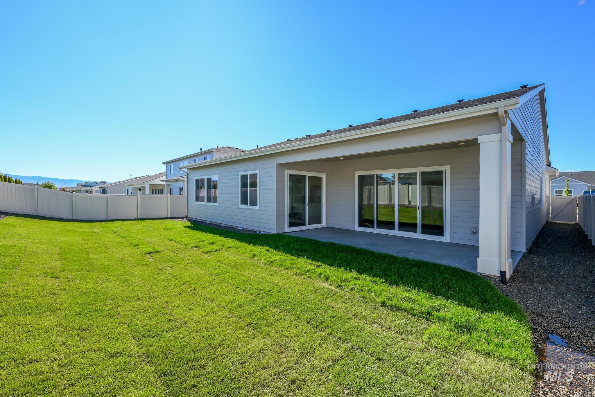 9074 West Moonglade Street Star, ID 83669 - Photo 29 of 40 Expansive green lawn with a covered concrete patio
