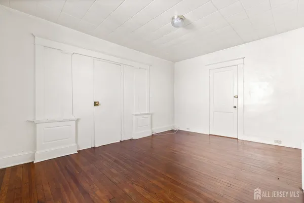 an empty room with wooden floor