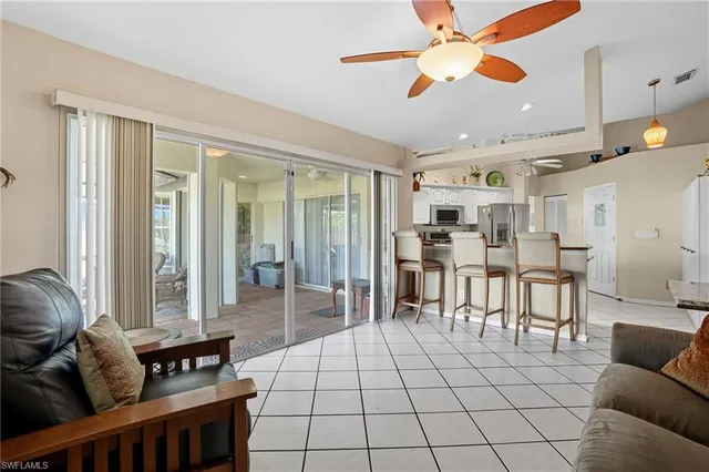 a living room with furniture and a dining table with wooden floor