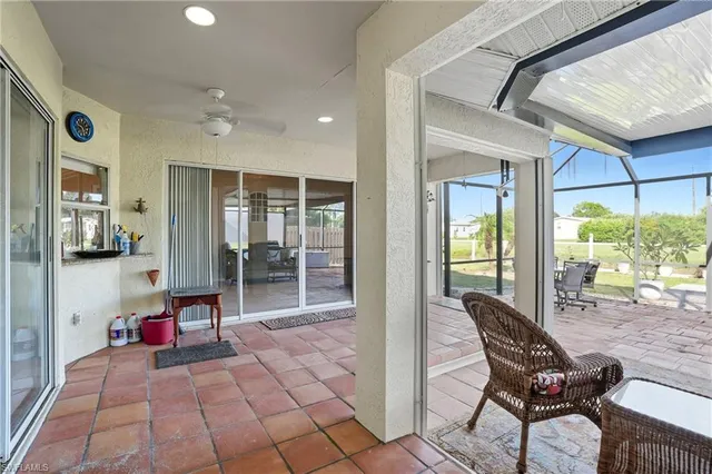 a view of a porch with chairs and backyard