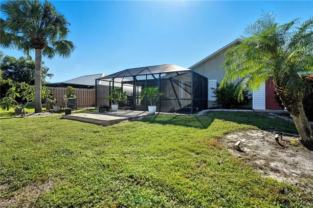 a swimming pool with outdoor seating and yard