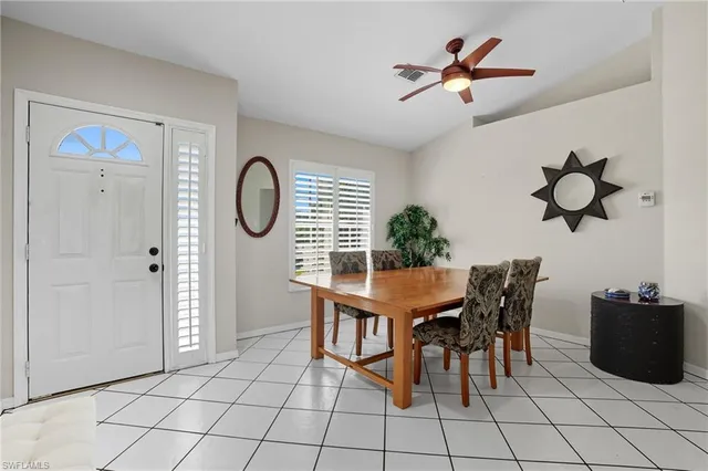 a dining room with furniture and window