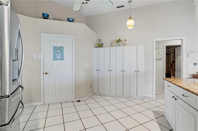 a view of a kitchen with cabinets and refrigerator