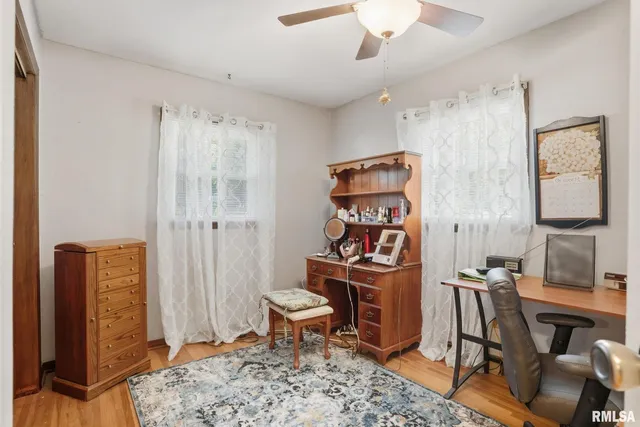 a reading room with furniture a rug and a window
