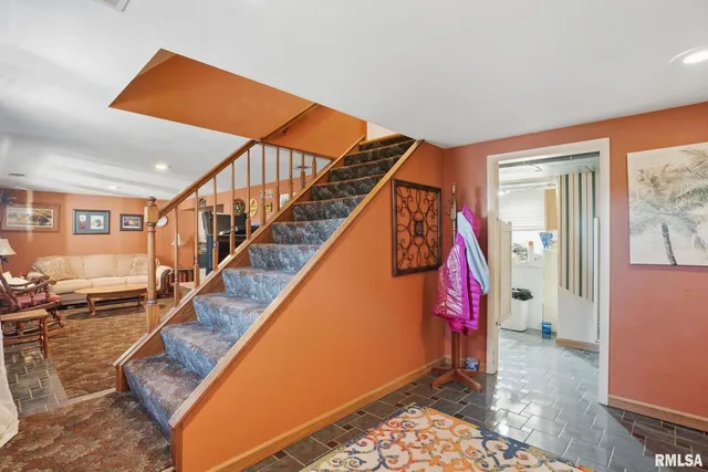 a living room with furniture gym equipment and a large window