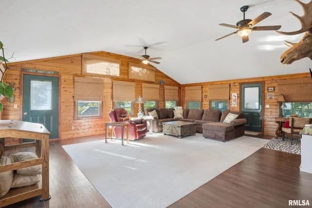 a living room with furniture a fireplace and a large window