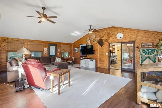 a living room with furniture a flat screen tv and a table