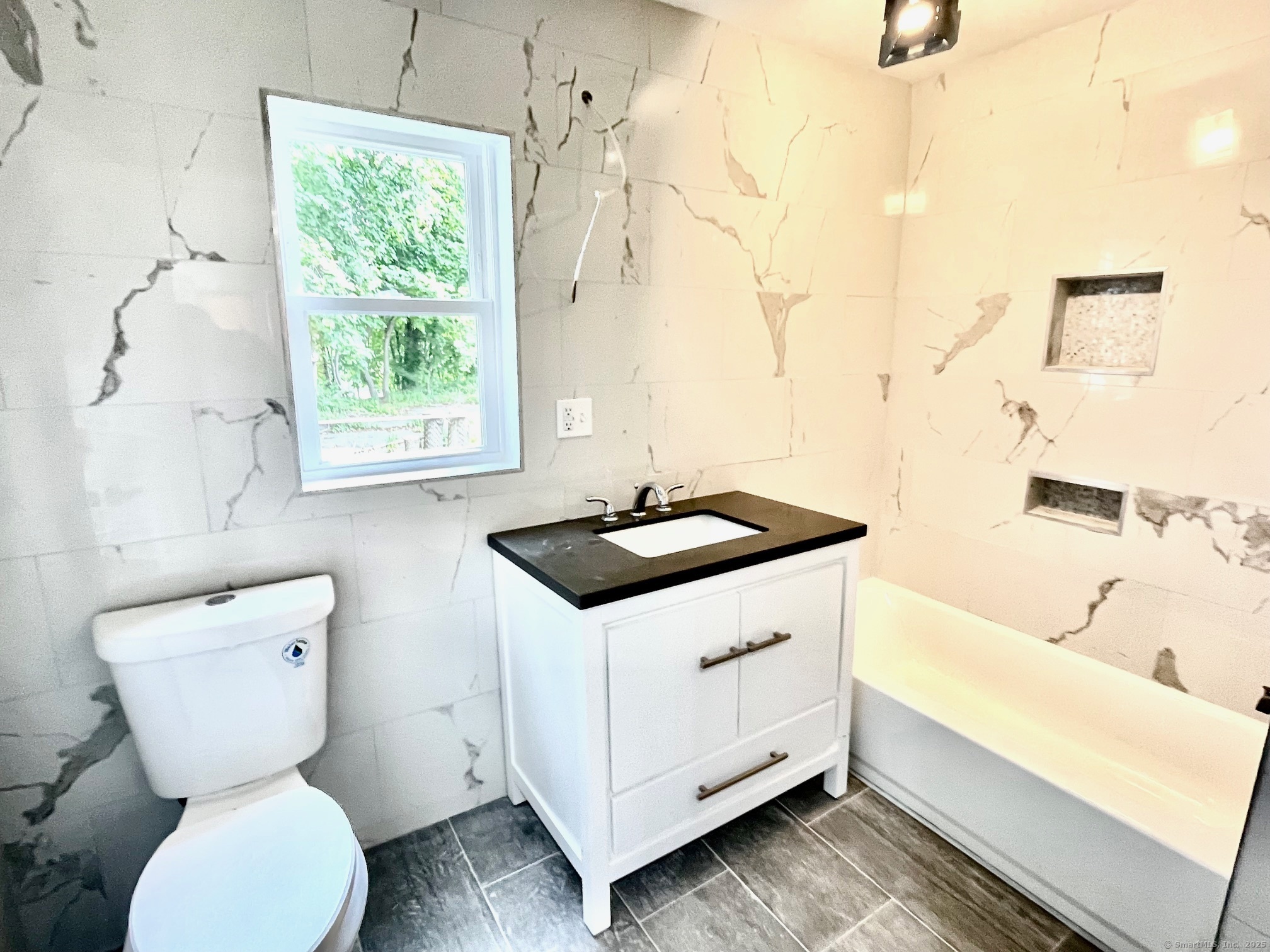 32 Lester Street Ansonia, CT 06401 - Photo 11 of 11 a bathroom with a sink a toilet and a bathtub