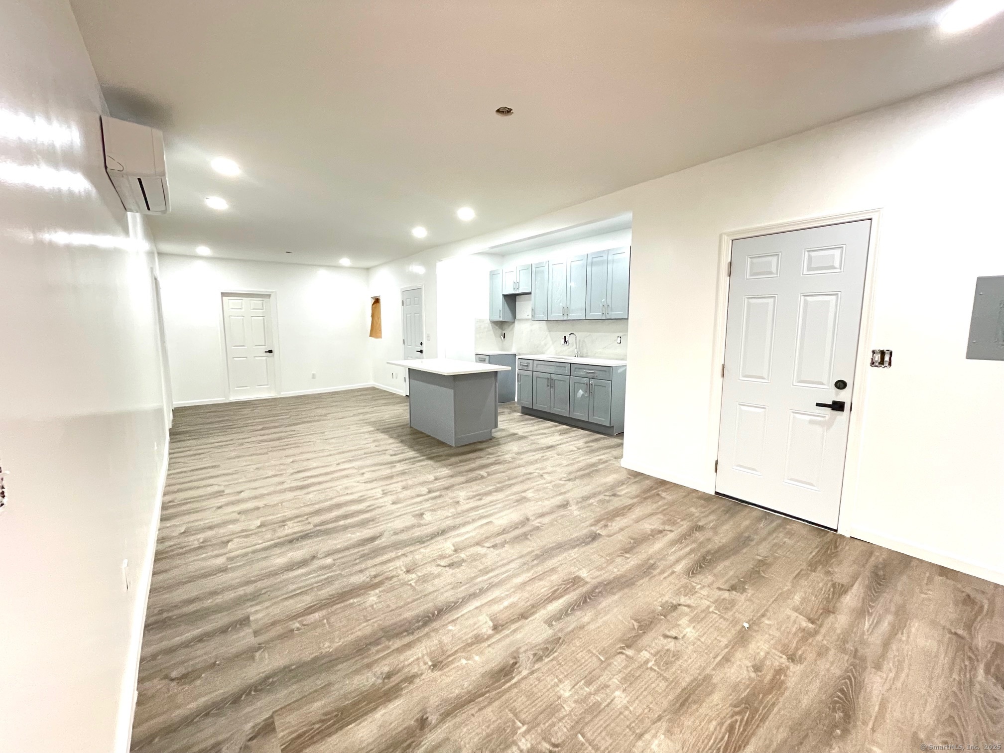 32 Lester Street Ansonia, CT 06401 - Photo 2 of 11 a view of a big room with wooden floor and windows