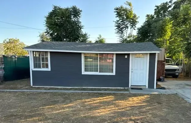 a house that has a tree in front of it