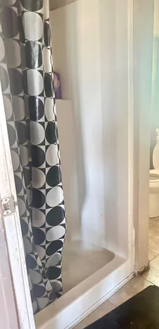 a bathroom with a glass door shower
