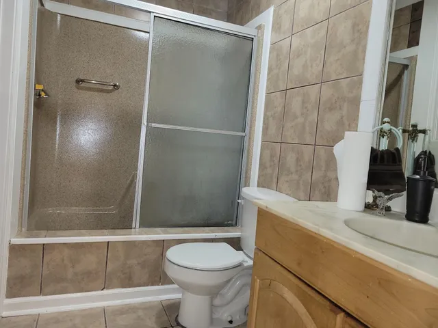 a bathroom with a sink toilet and mirror