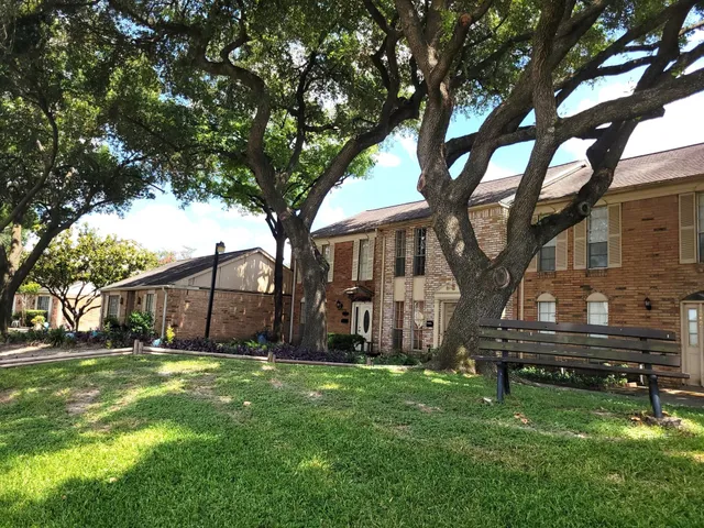 a view of a park with a large tree