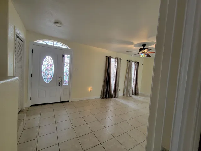 a view of a livingroom with wooden floor and a chandelier