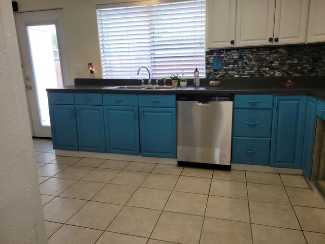 a kitchen with stainless steel appliances granite countertop a refrigerator stove and sink