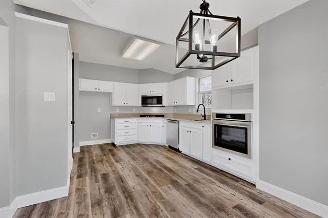 a kitchen with a white cabinets and white appliances