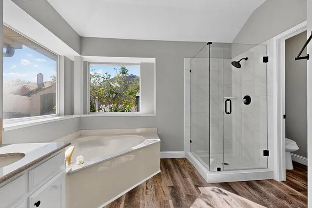 a bathroom with a tub and a shower