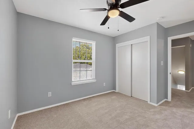 an empty room and chandelier fan