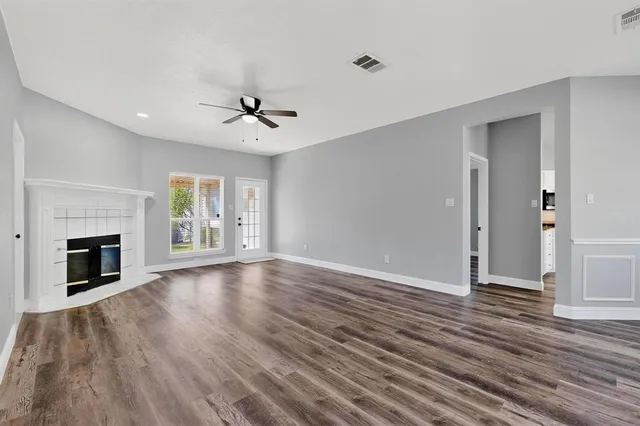 wooden floor in an empty room with a fireplace