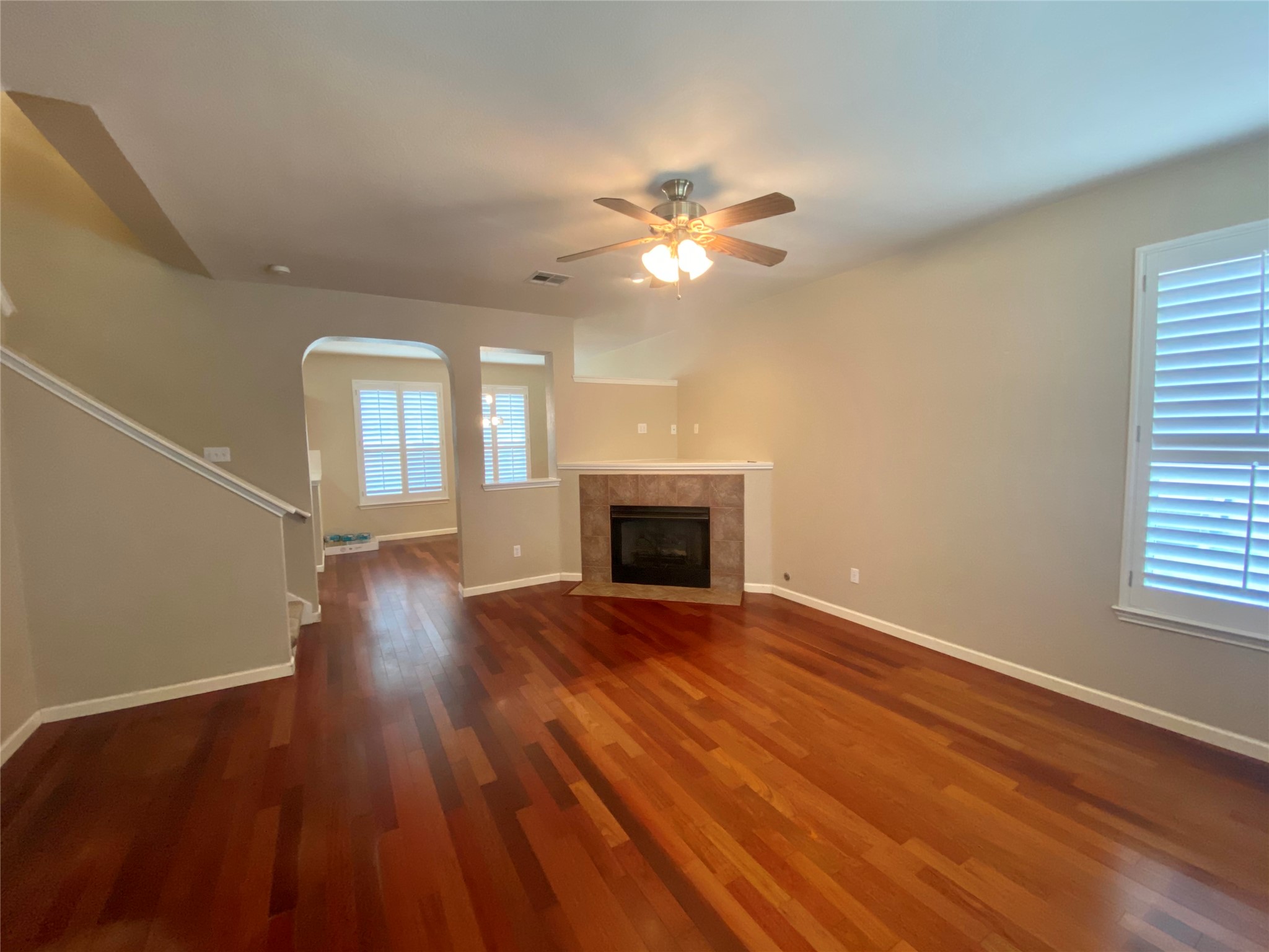4615 Tello Path Austin, TX 78749 - Photo 2 of 29 Warm hardwood flooring flows through this comfortable living space, featuring a cozy fireplace.