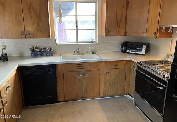a kitchen with a sink stove and cabinets