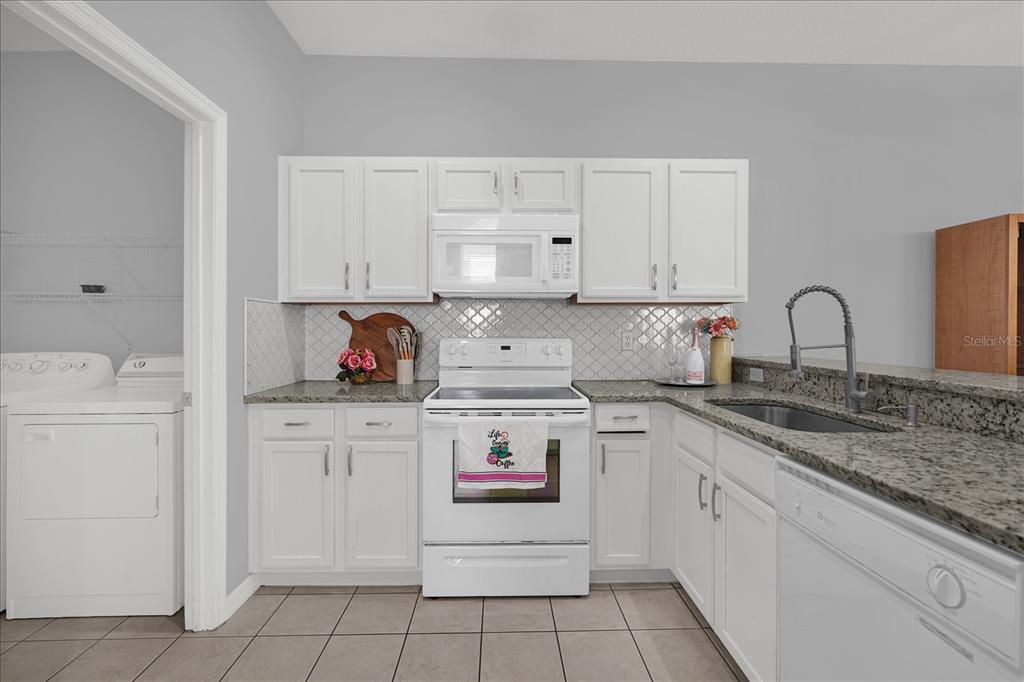 1453 Royal Ridge Drive Davenport, FL 33896 - Photo 11 of 32 a kitchen with cabinets appliances and a sink