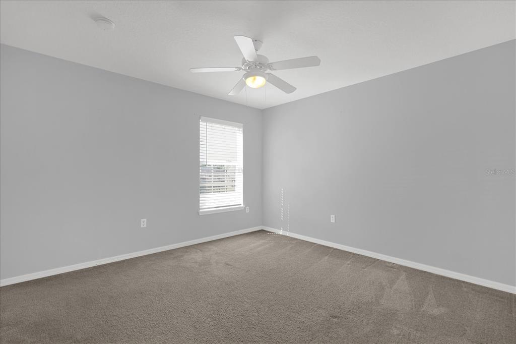1453 Royal Ridge Drive Davenport, FL 33896 - Photo 12 of 32 an empty room with a window and a fan