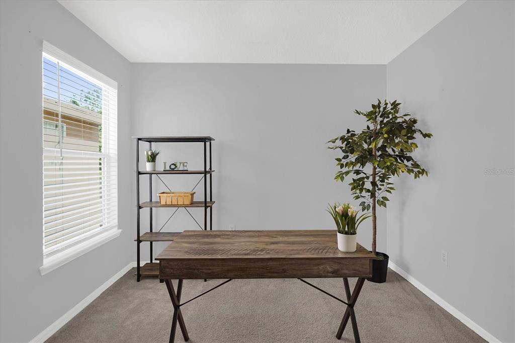 1453 Royal Ridge Drive Davenport, FL 33896 - Photo 16 of 32 a room with a table chair and a potted plant