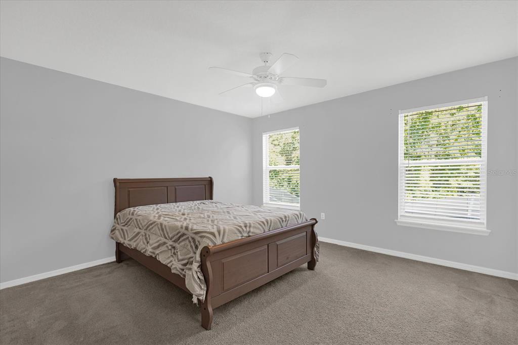 1453 Royal Ridge Drive Davenport, FL 33896 - Photo 17 of 32 a bed sitting in a bedroom next to a window