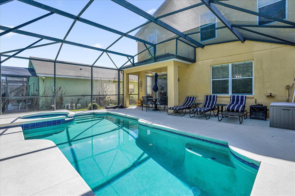 1453 Royal Ridge Drive Davenport, FL 33896 - Photo 2 of 32 a view of a patio with a table and chairs under an umbrella