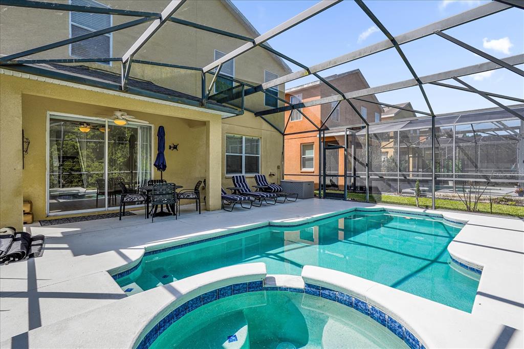 1453 Royal Ridge Drive Davenport, FL 33896 - Photo 26 of 32 a swimming pool with outdoor seating and yard