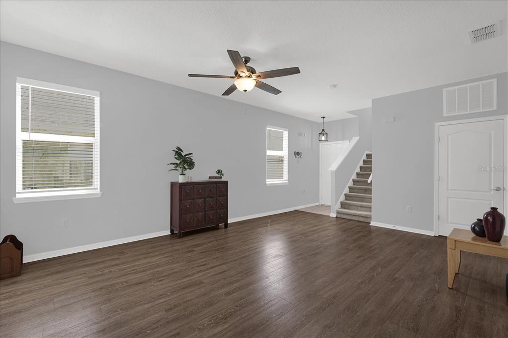 1453 Royal Ridge Drive Davenport, FL 33896 - Photo 5 of 32 a view of an empty room with wooden floor and a window
