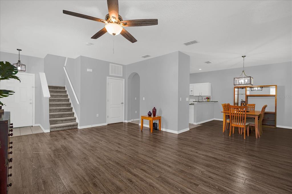 1453 Royal Ridge Drive Davenport, FL 33896 - Photo 6 of 32 a view of a dining room with furniture and wooden floor