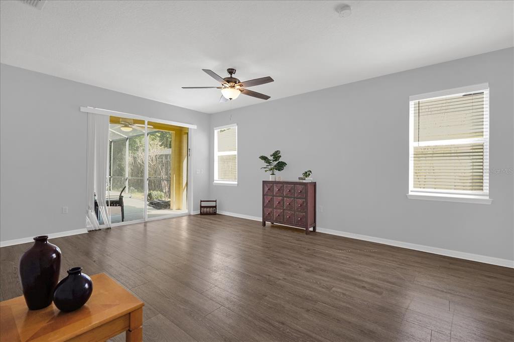 1453 Royal Ridge Drive Davenport, FL 33896 - Photo 7 of 32 a view of an empty room with a window and wooden floor