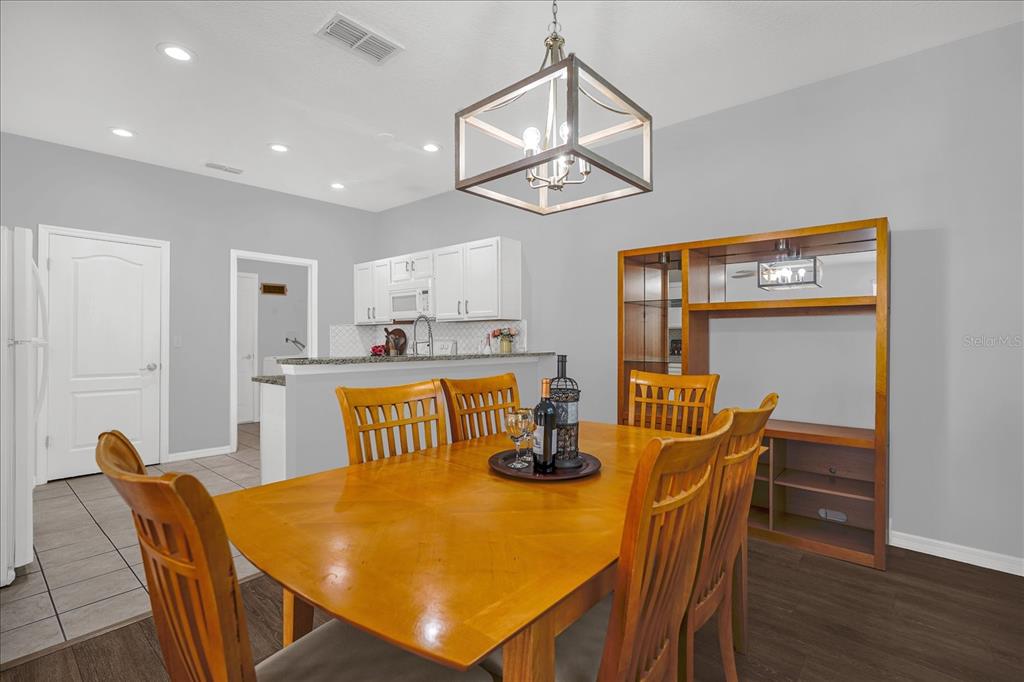 1453 Royal Ridge Drive Davenport, FL 33896 - Photo 9 of 32 a view of a dining room with furniture and wooden floor