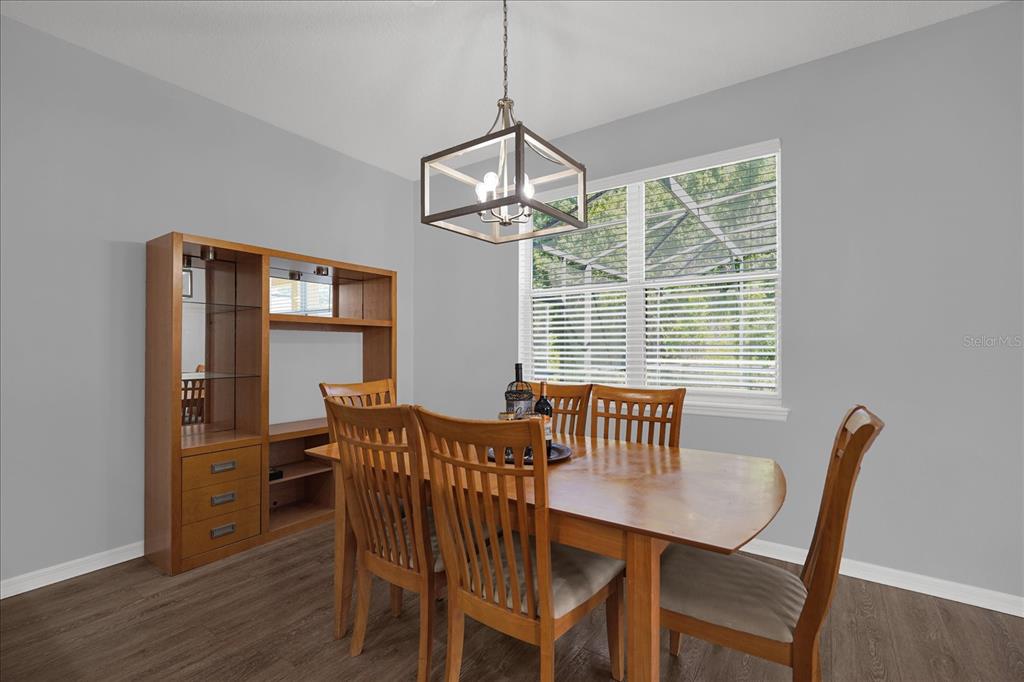 1453 Royal Ridge Drive Davenport, FL 33896 - Photo 10 of 32 a view of a dining room with furniture window and wooden floor
