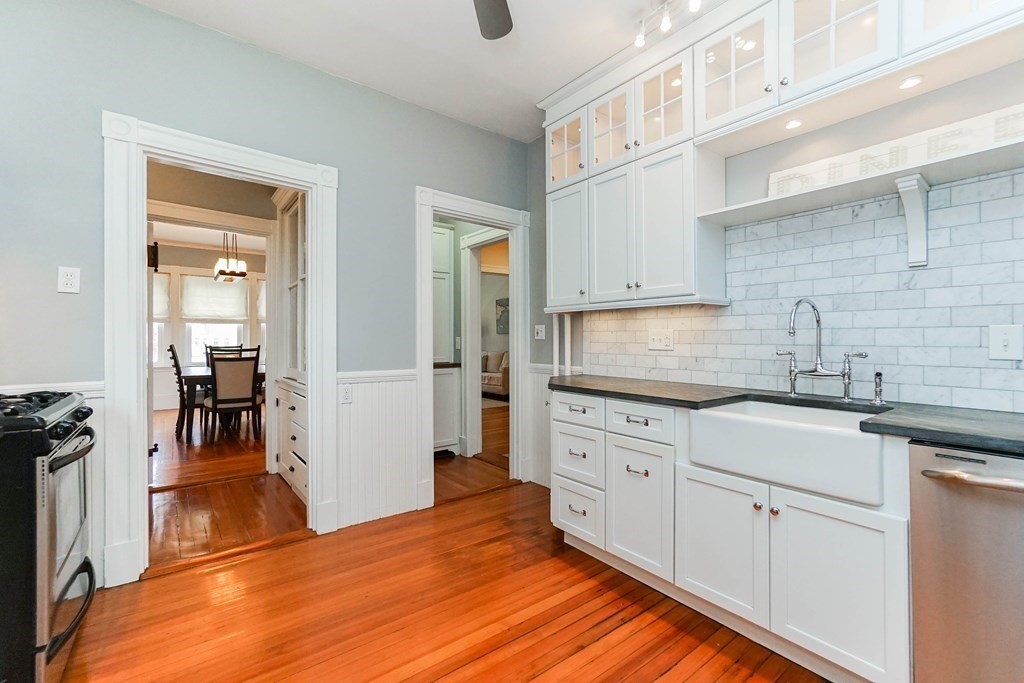 17 Park Vale, Unit 4 Brookline, MA 02446 - Photo 12 of 24 a kitchen with granite countertop white cabinets and white appliances