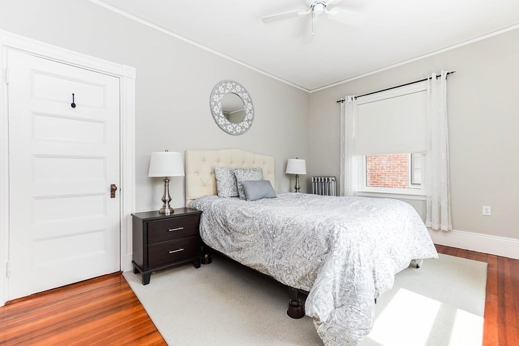 17 Park Vale, Unit 4 Brookline, MA 02446 - Photo 14 of 24 a bedroom with a bed and a chandelier