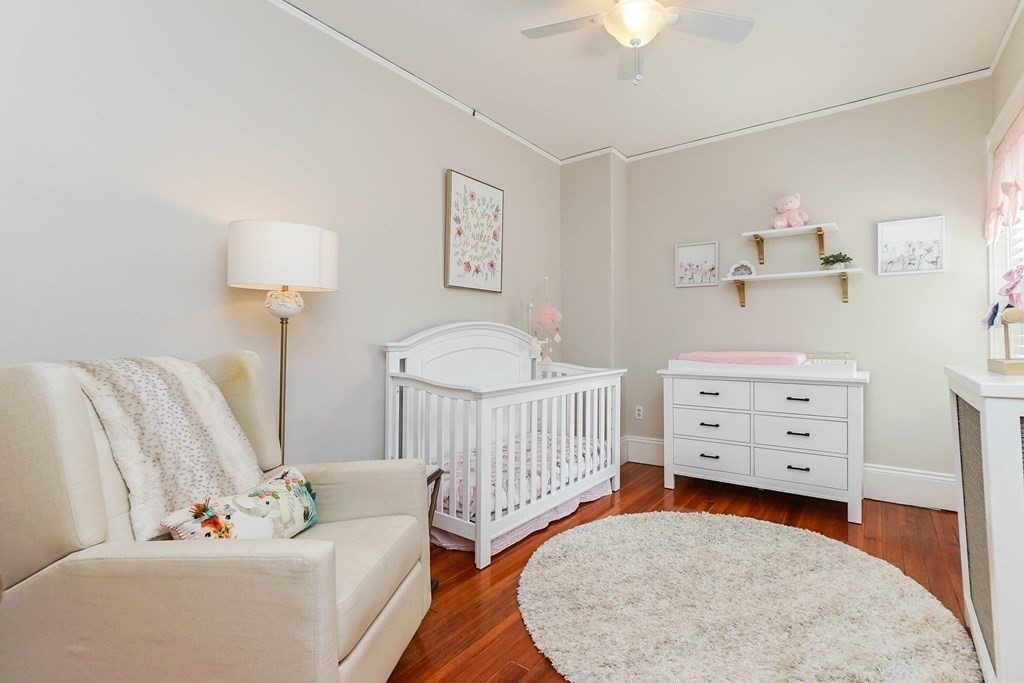 17 Park Vale, Unit 4 Brookline, MA 02446 - Photo 17 of 24 a living room with furniture and a baby crib
