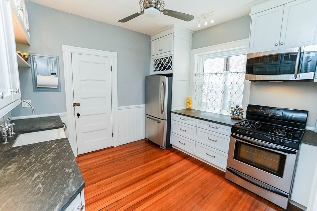 17 Park Vale, Unit 4 Brookline, MA 02446 - Photo 10 of 24 a kitchen with stainless steel appliances a stove microwave and a refrigerator