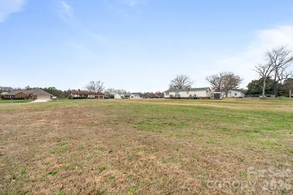 a view of a field with an ocean