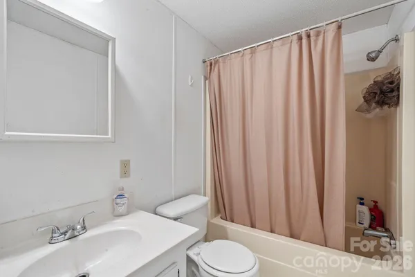 a view of a field with an trees in front of it