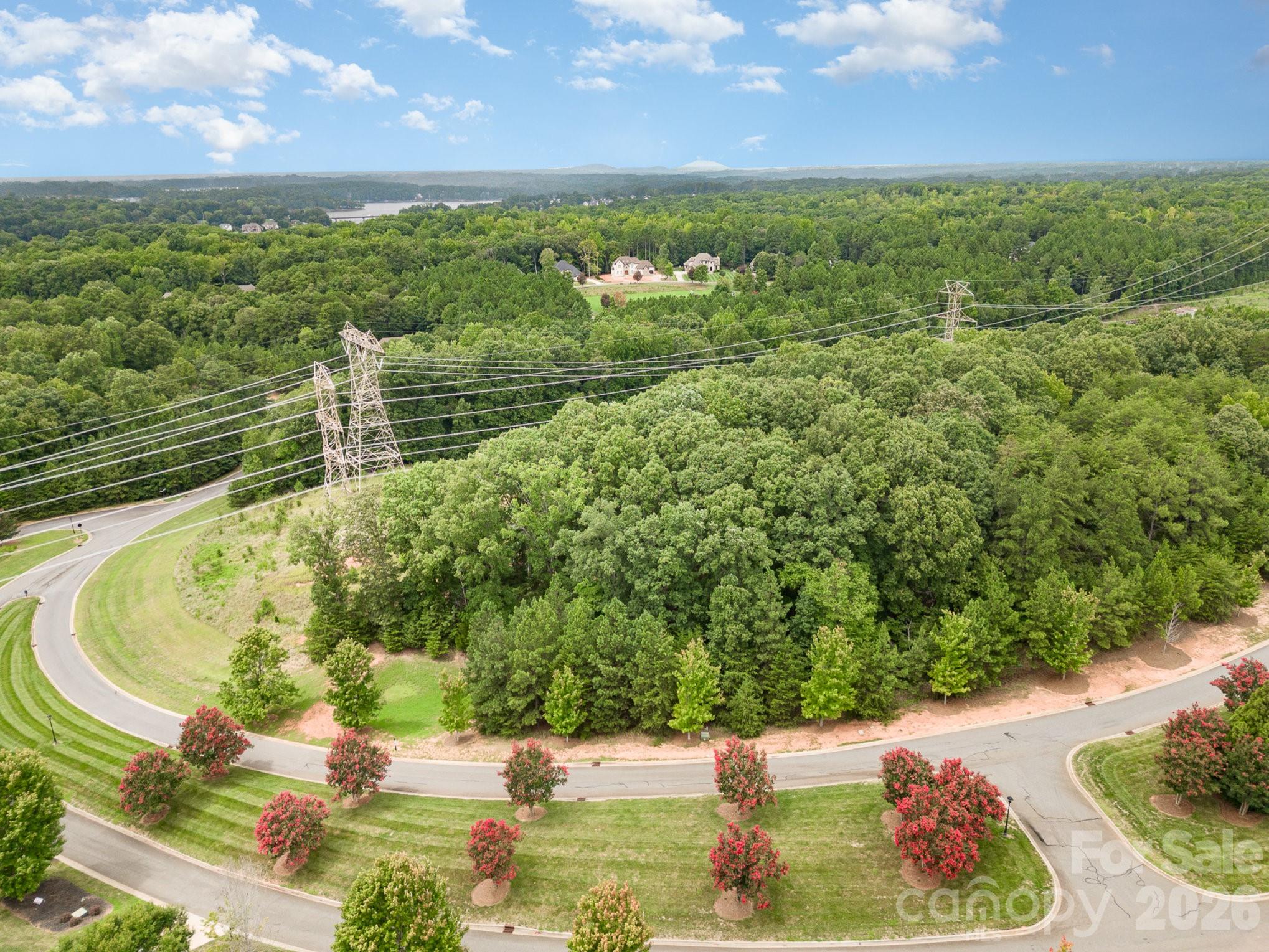 1400 Reflection Pointe Boulevard, Unit 327 Belmont, NC 28012 - Photo 2 of 19 a view of a lake with a yard
