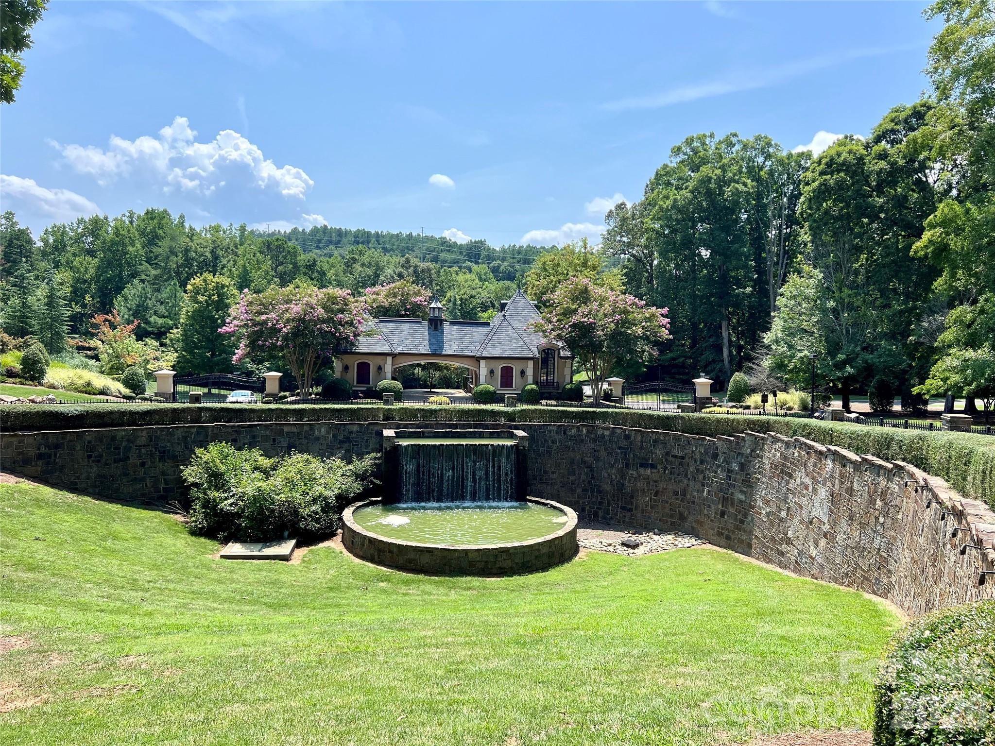 1400 Reflection Pointe Boulevard, Unit 327 Belmont, NC 28012 - Photo 3 of 19 a view of a lake with a yard
