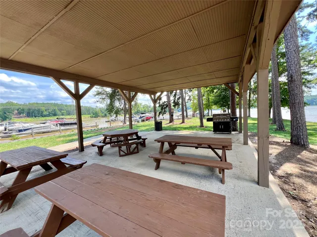 a view of a swimming pool with chairs in patio