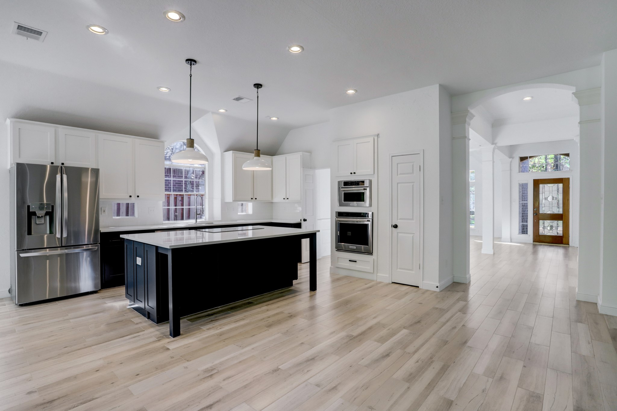 138 Summer Storm Place Spring, TX 77381 - Photo 6 of 20 An open-concept layout creates an easy flow between the family room, kitchen and formal living areas.