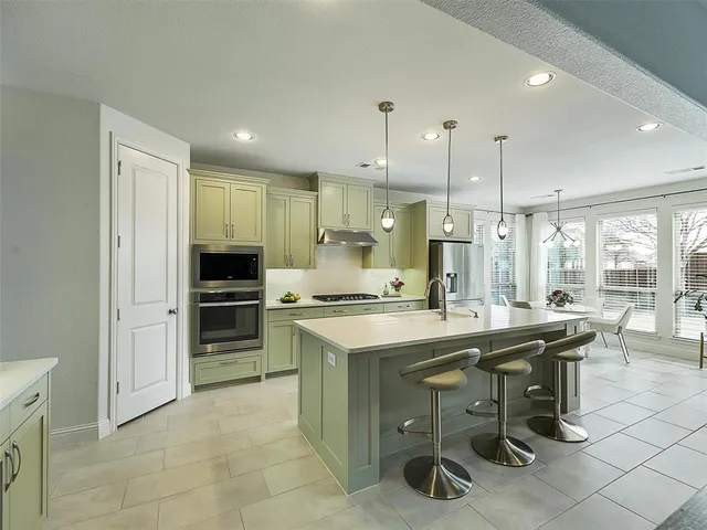 a kitchen with kitchen island cabinets and refrigerator