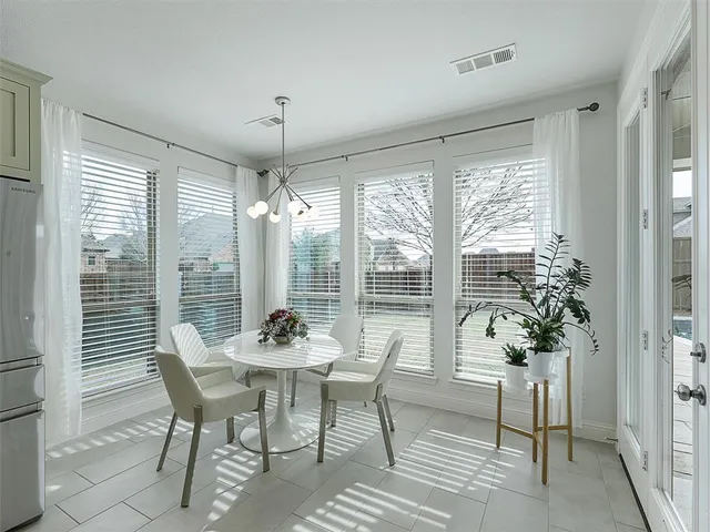 a dining room with furniture window and wooden floor