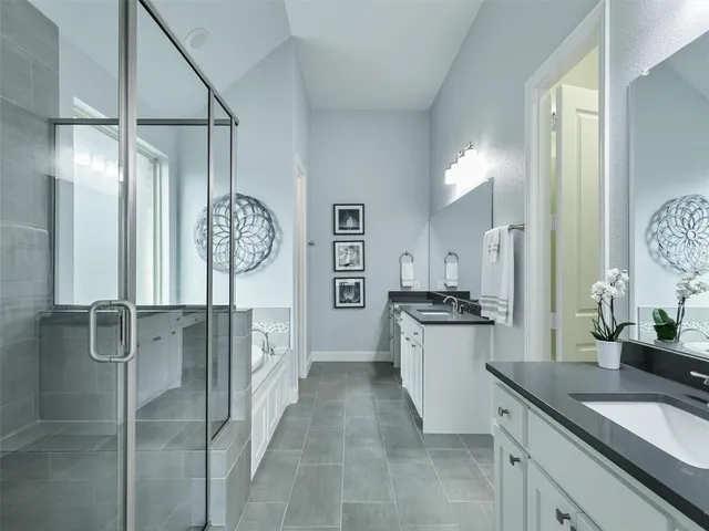 a kitchen with stainless steel appliances granite countertop a refrigerator a stove and a sink